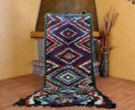 Vintage moroccan rug featuring delicately colorful Boujaad designs. A stunning handmade vintage rug serving as an elegant vintage berber rug and authentic berber rug.